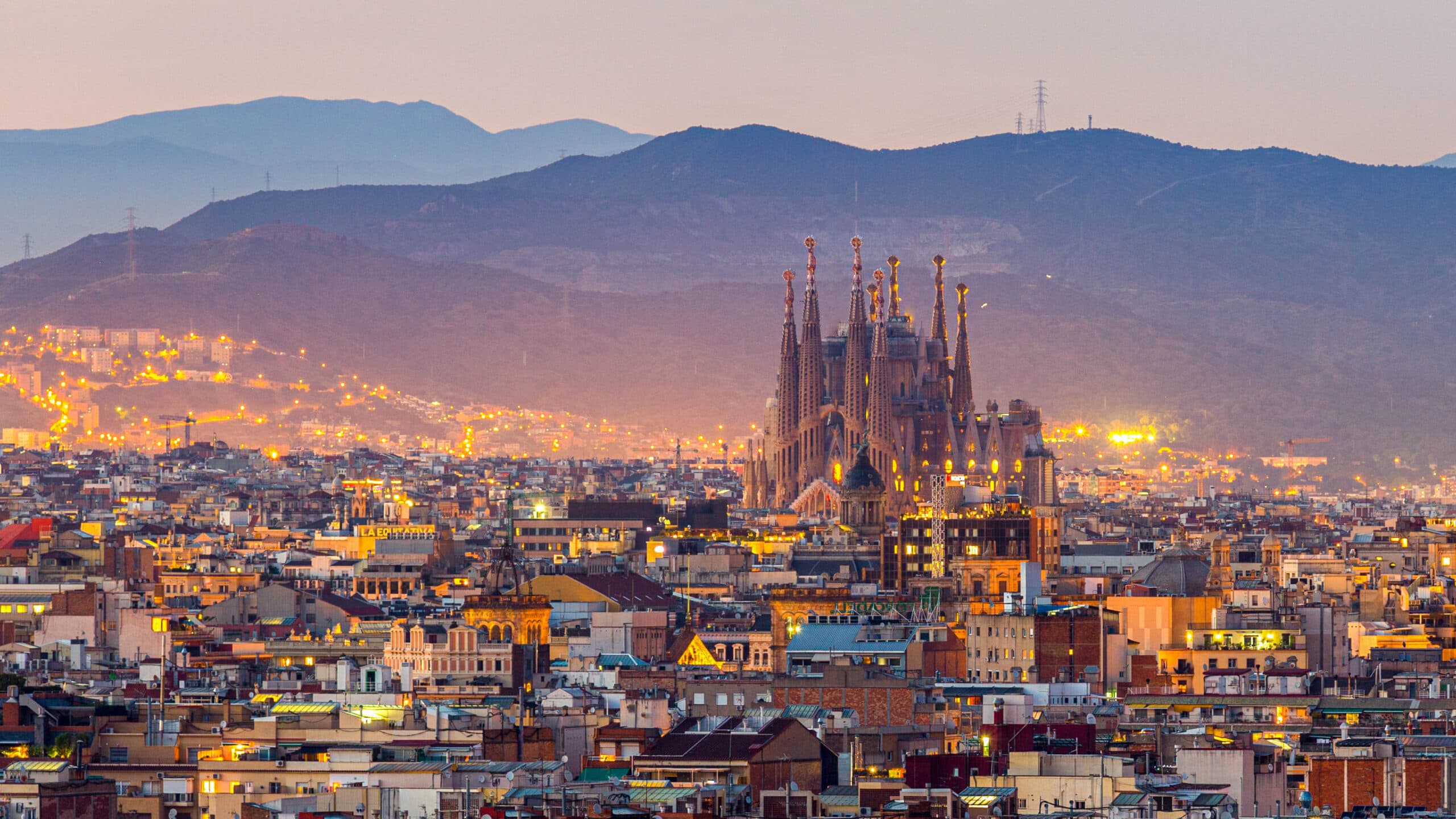 Aerial view of the Barcelona skyline and Sagrada Família at dusk